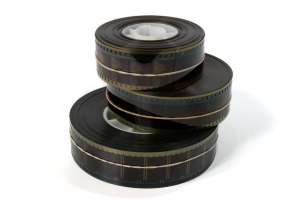 A stack of three 35mm movie film trailers - on white